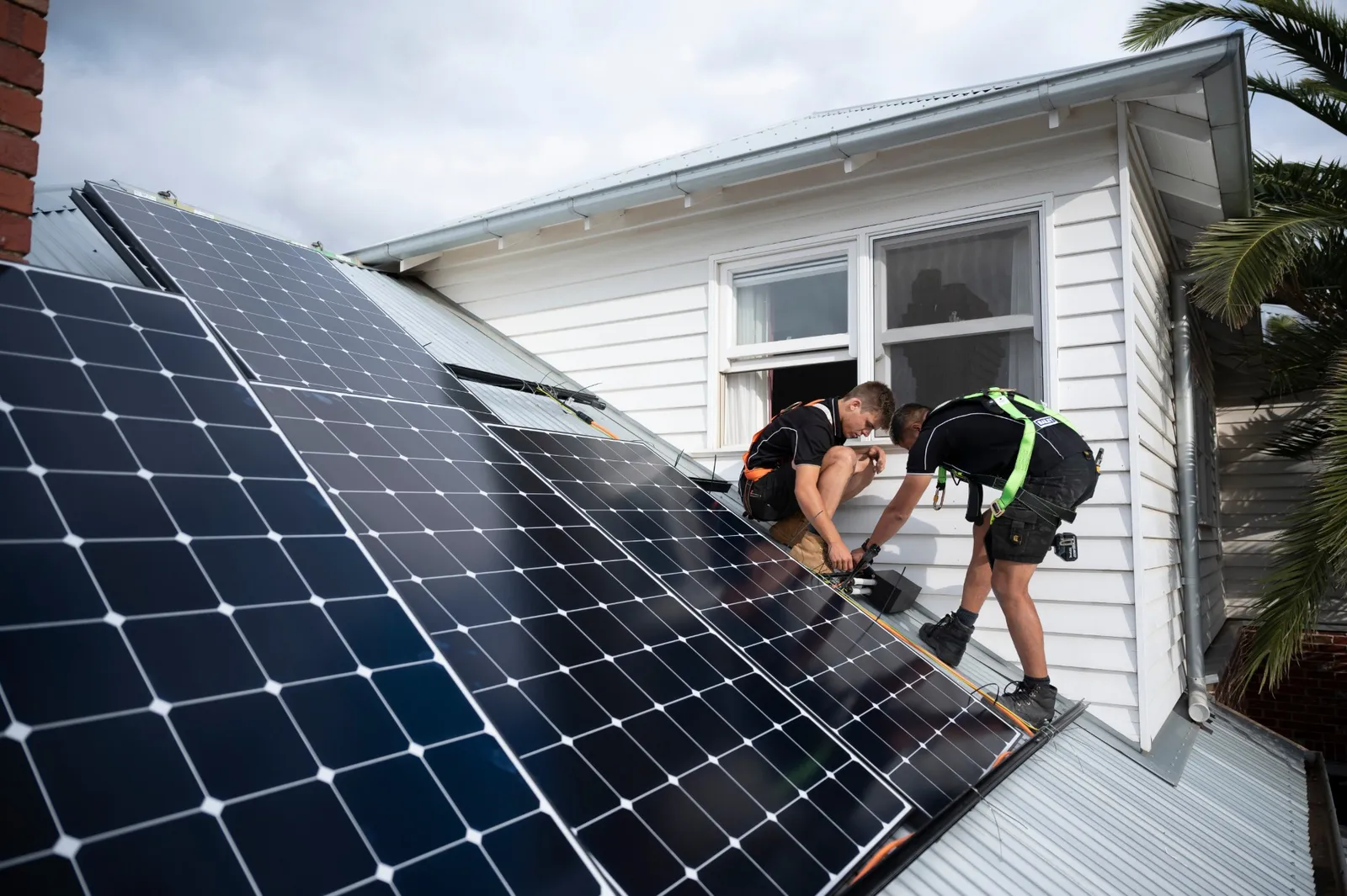 A solar installation crew on a roof